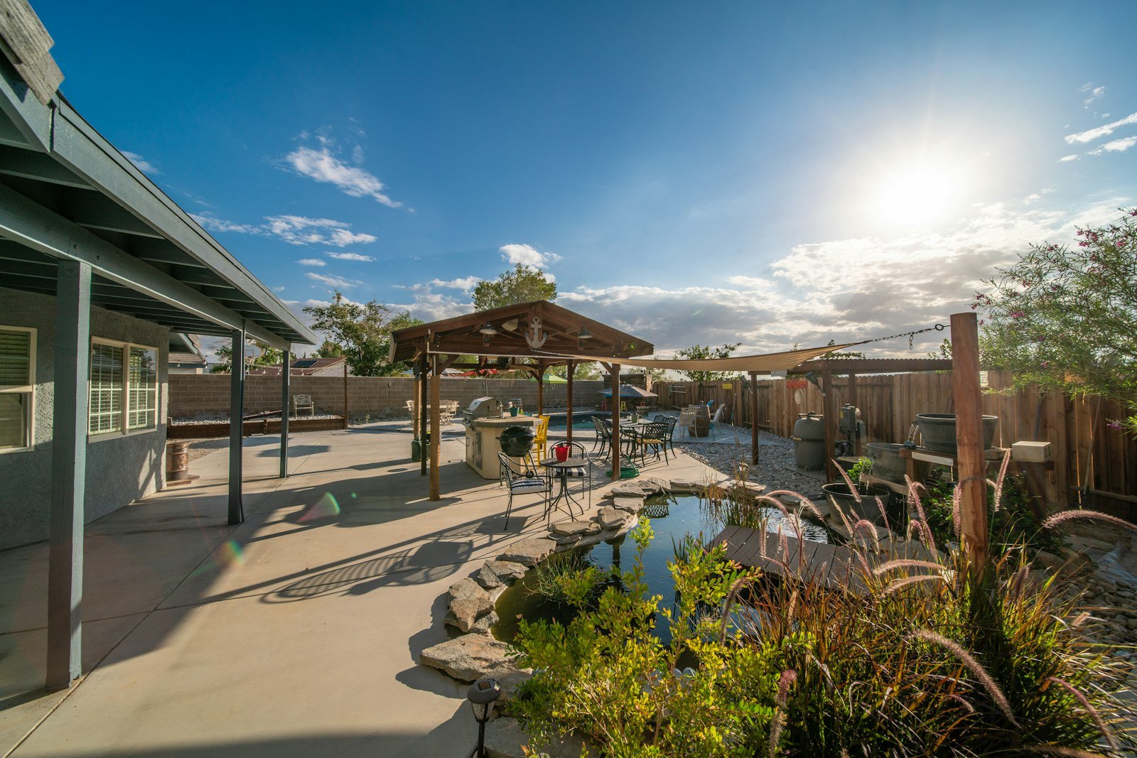 Landscaped backyard with a small pond and a gazebo.